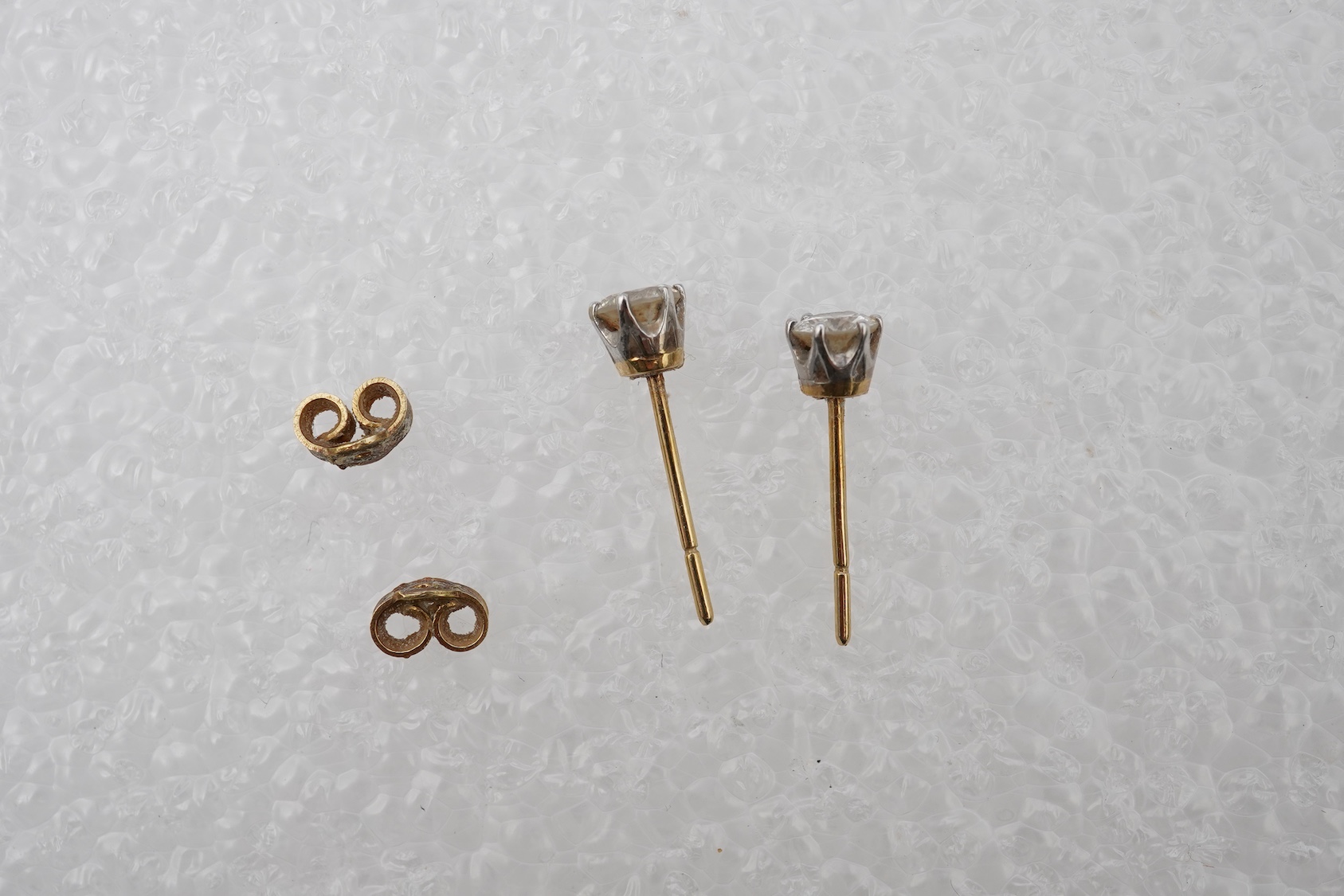 A pair of diamond stud earrings